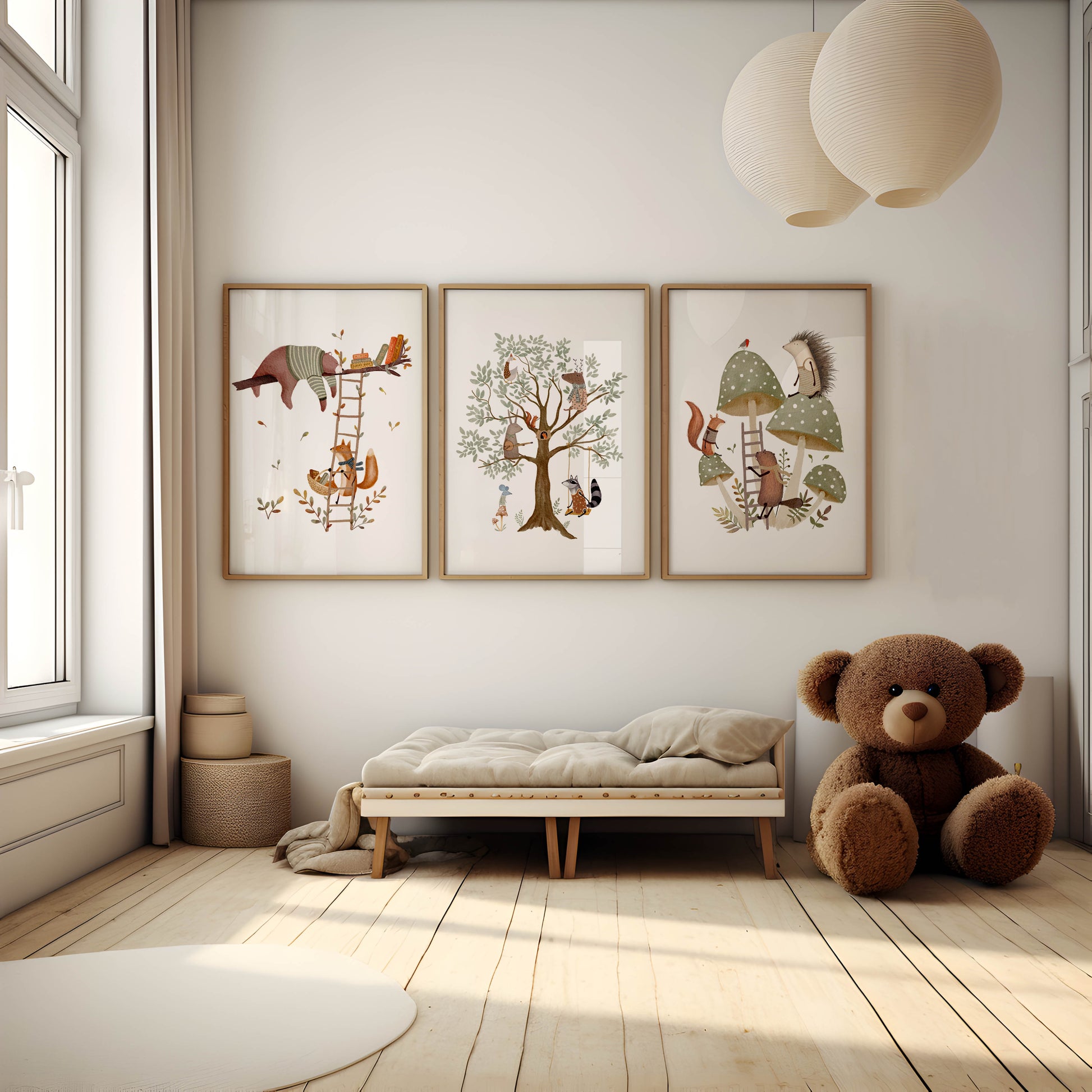 Set of three framed art prints showing woodland animals in playful scenes with trees and mushrooms, displayed above a daybed in a bright, modern nursery.