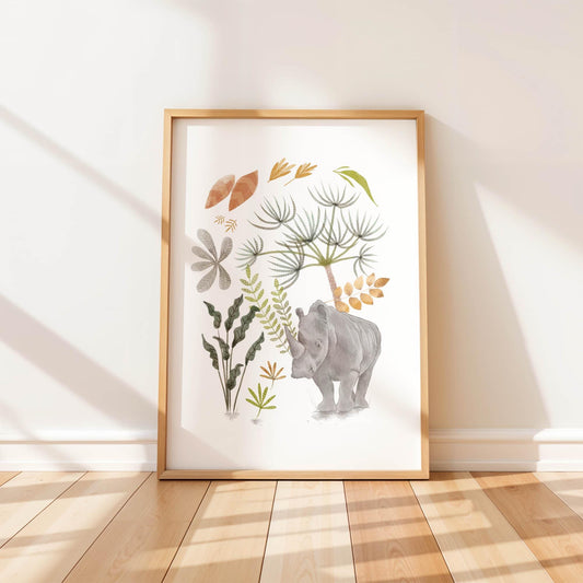 A single framed art print leaning against a white wall, featuring a hand-painted watercolor illustration of a rhino surrounded by boho botanical leaves and plants.